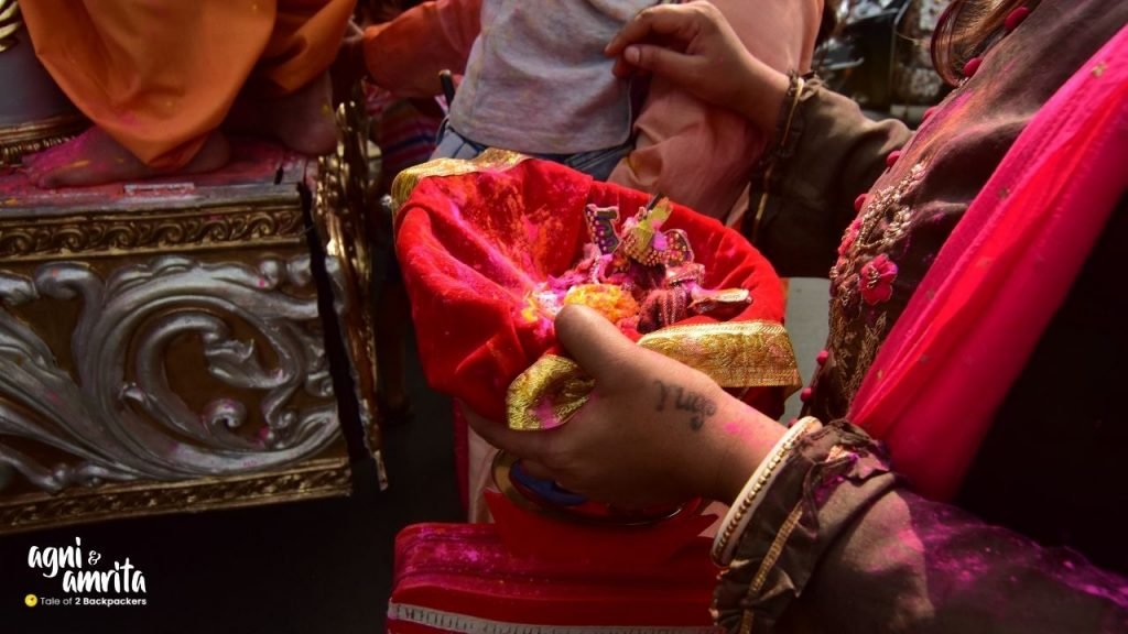 A woman carrying Satyanarayan Deity