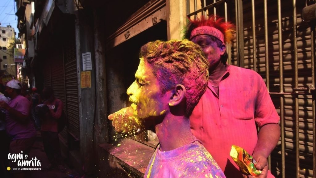 Smearing colours on the face during Holi